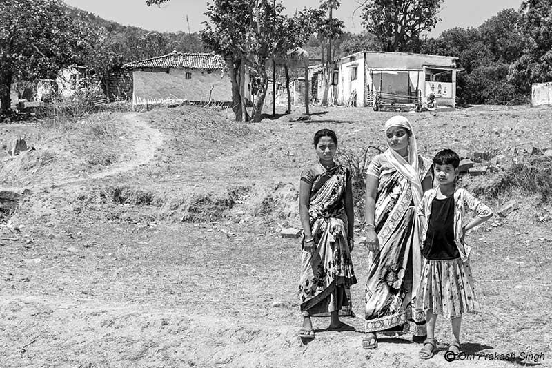 Inhabitants of an isolated hamlet belonging to a Particularly Vulnerable Tribal Group (PVTG) which lies uncovered under Jal Jeevan Mission due to lack of road connectivity in Gumla district, Jharkhand, India